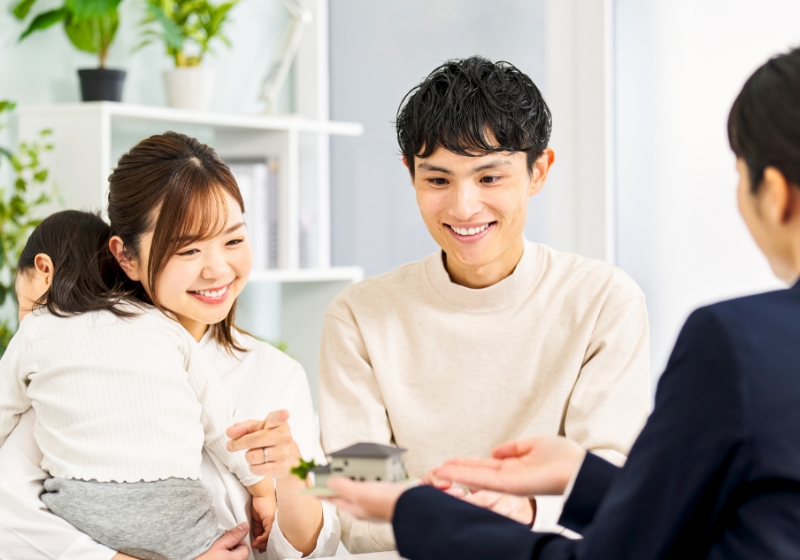 お父さん・お母さん抱かれている岡ちゃんと後ろ姿の女性の写真